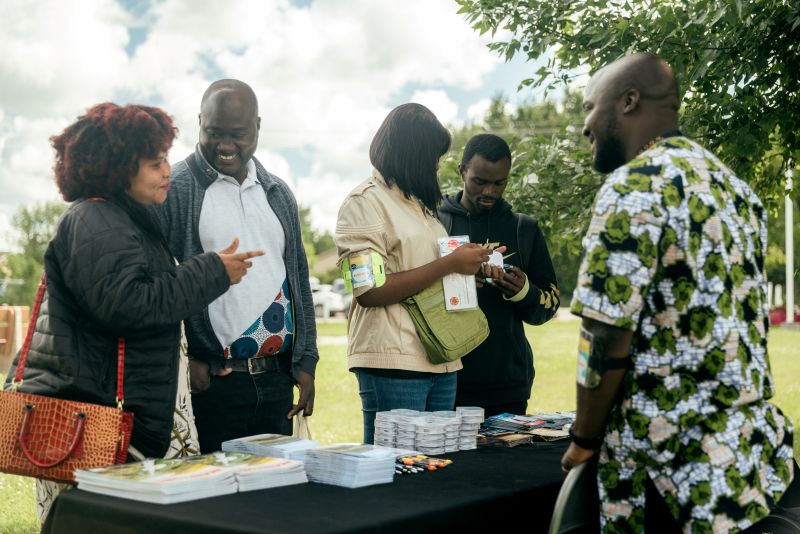 Des participants à la journée d'accueil des nouveaux arrivants de la CFA-Seine au parc Spirit de Lorette sont debout autour d'une table de kiosque et discute de service offert dans la communauté .